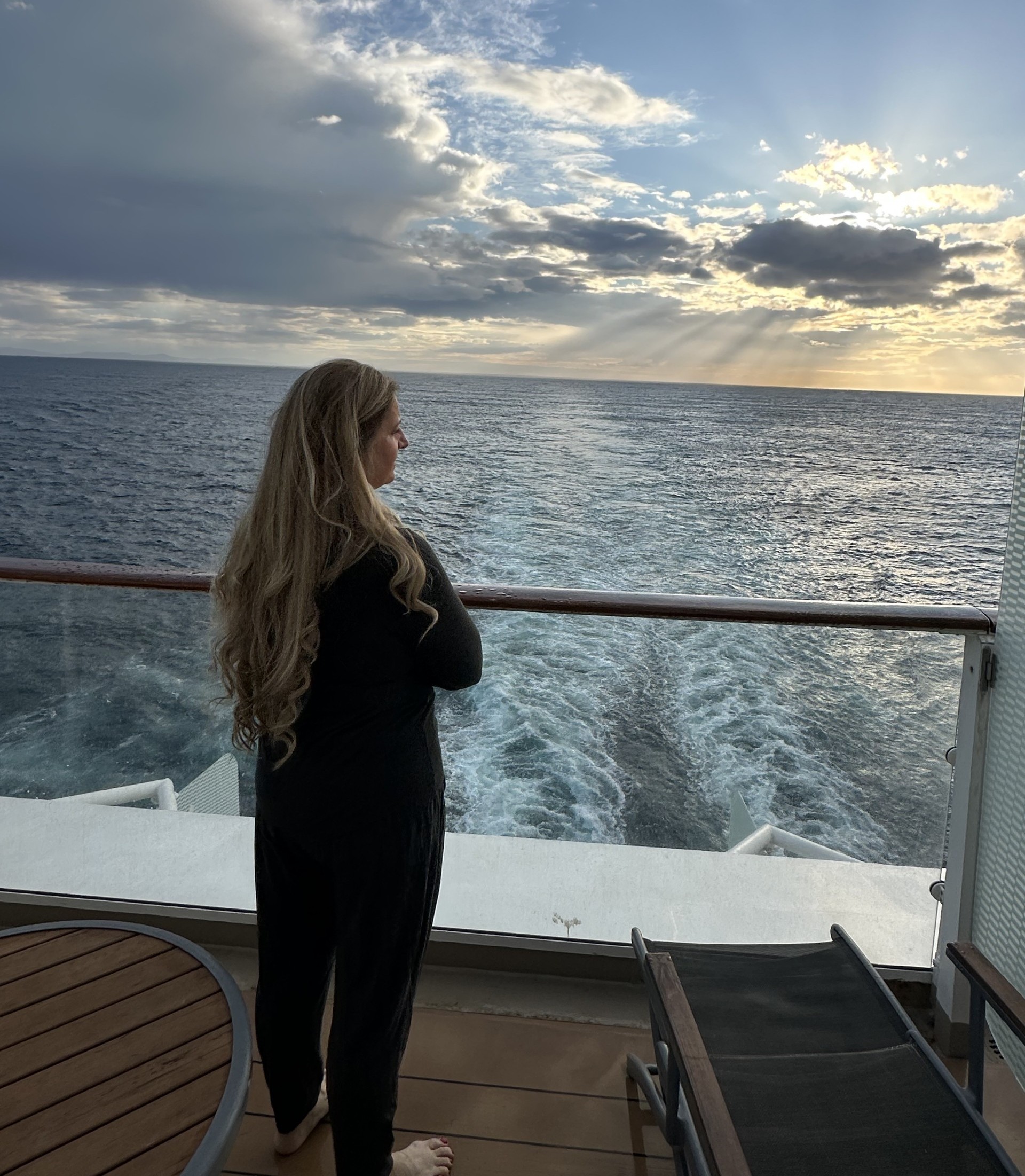 Travel advisor watching the sunset from a cruise ship balcony during a British Isles voyage