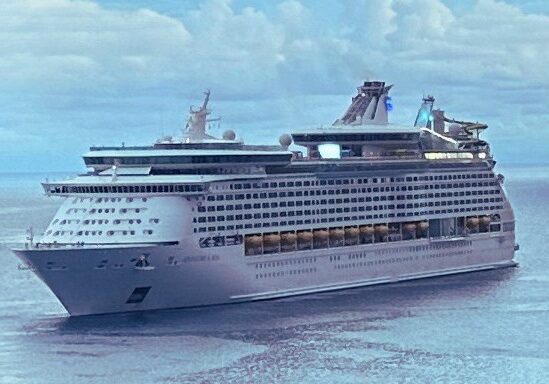 Ocean cruise ship sailing on calm open water representing ocean and river cruising.